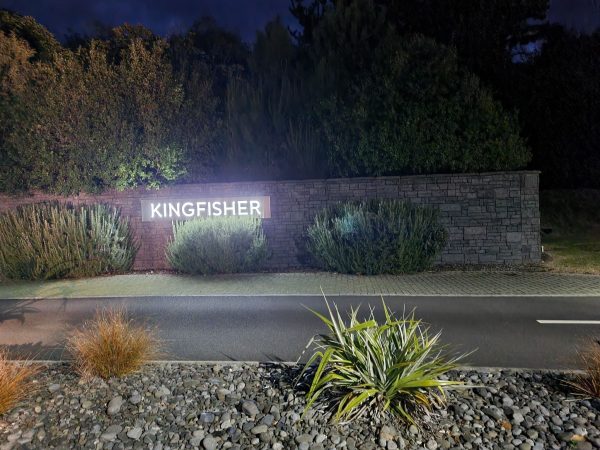 Kingfisher gated community illuminated sign at night in Taupō
