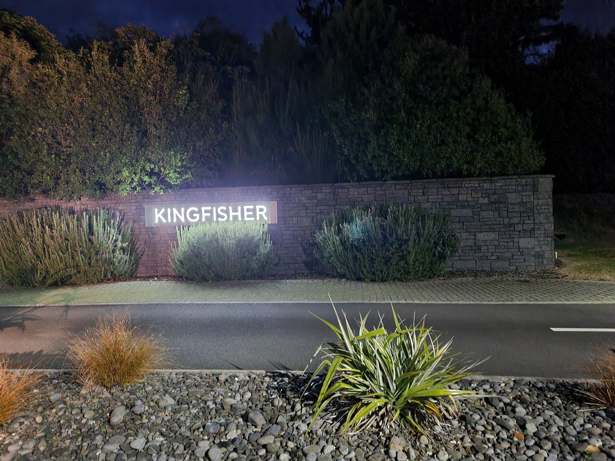 Kingfisher gated community illuminated sign at night in Taupō